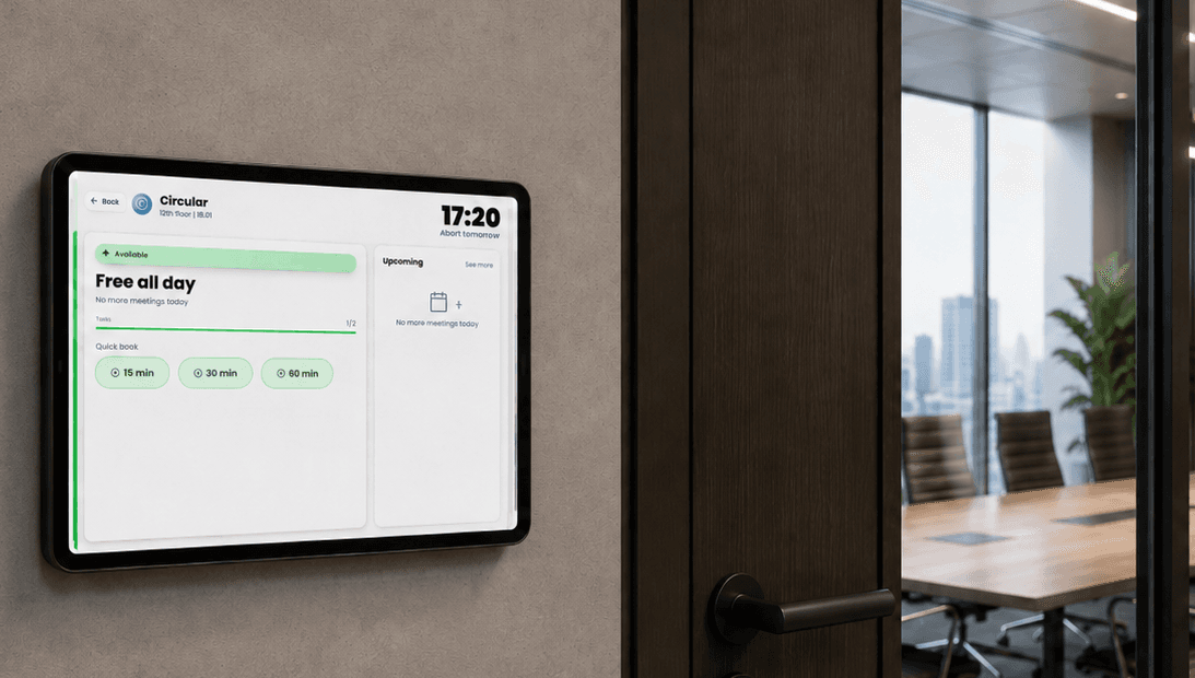 Boardly running on a wall-mounted tablet beside a boardroom door, displaying current room status and time.