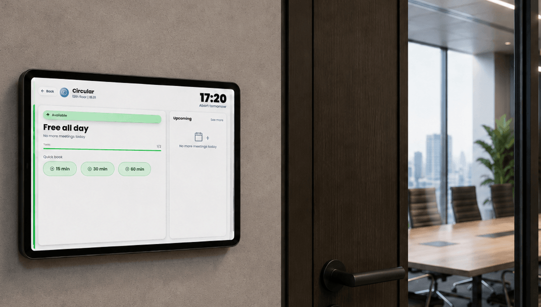 Boardly on a wall-mounted tablet beside a boardroom door, showing the room's status.